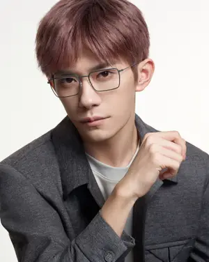 Man in gray blazer and white shirt with glasses on