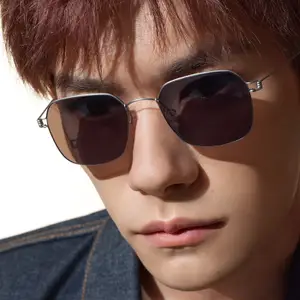 A close up of a man with sunglasses and a denim jacket