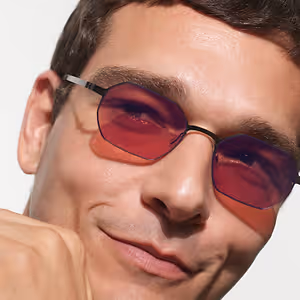 close up of a man wearing glasses with red lenses