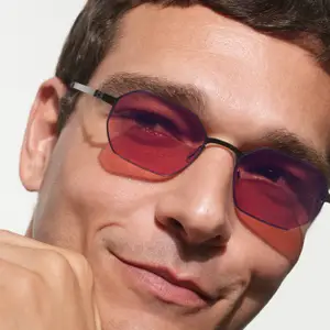 close up of a man wearing glasses with red lenses