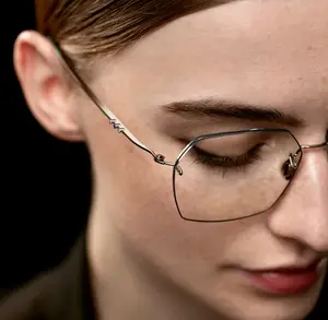 Close-up of a woman wearing eyeglasses with a slight smile on her face