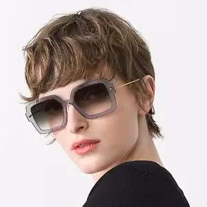 Woman wearing a pair of sunglasses with a short haircut