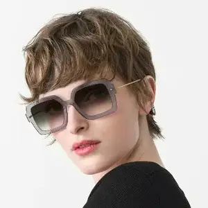 Woman wearing a pair of sunglasses with a short haircut