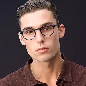 A man with eyeglasses and a maroon shirt is posing for a photo