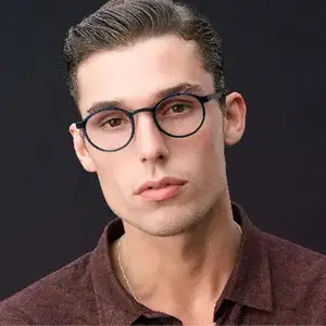 A man with eyeglasses and a maroon shirt is posing for a photo