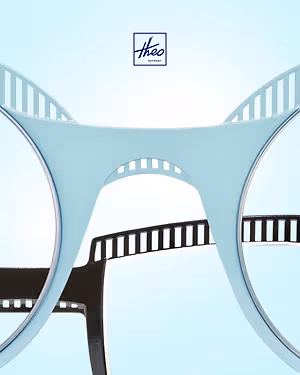 Blue Theo eyewear glasses with a black film strip design on a blue background