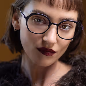Close up of woman wearing glasses and a fur coat