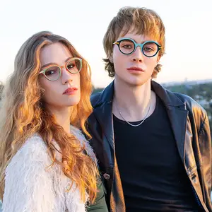 A man and woman with glasses in a rooftop photo