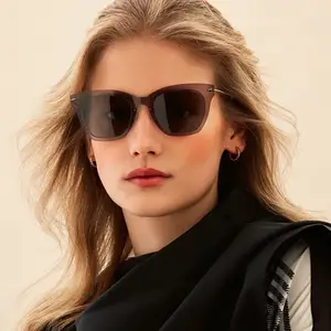 Closeup of a woman wearing sunglasses with brown frames and dark lenses.