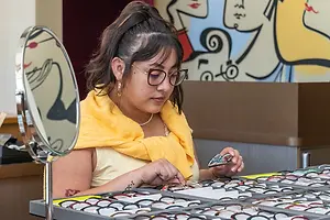A woman is trying on glasses in a mirror at a store