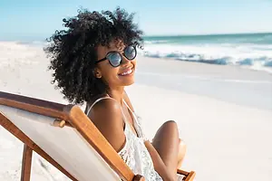 Woman sitting on a beach chair and smiling