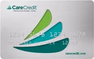 Image of a CareCredit card with a green leaf design, featuring the card number and expiration date.