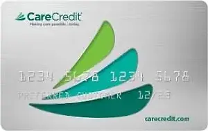 Image of a CareCredit card with a green leaf design, featuring the card number and expiration date.