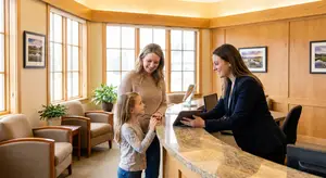 woman and girl in front of a reception desk