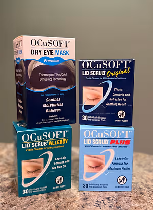 Three boxes of Ocusoft products are arranged on a marble countertop, each featuring eye images and text indicating soothing relief for various eye conditions.