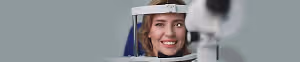Close up of woman having her eyes examined by a doctor in an optician office.