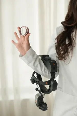 A woman holding a magnifying glass in a white lab coat.