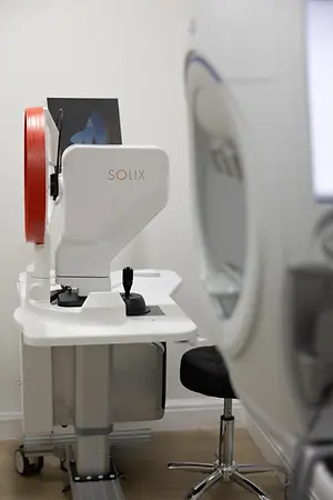 Solix eye examination device beside an optometry stool