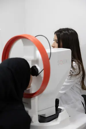 Optometrist performing an eye exam with a patient using a Solix imaging device