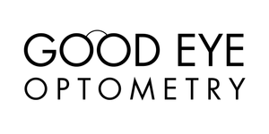 Image of a woman standing near a white wall with her hair blowing in the wind.
