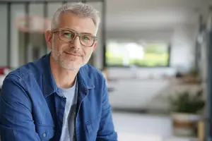 Portrait of a smiling man in a home office