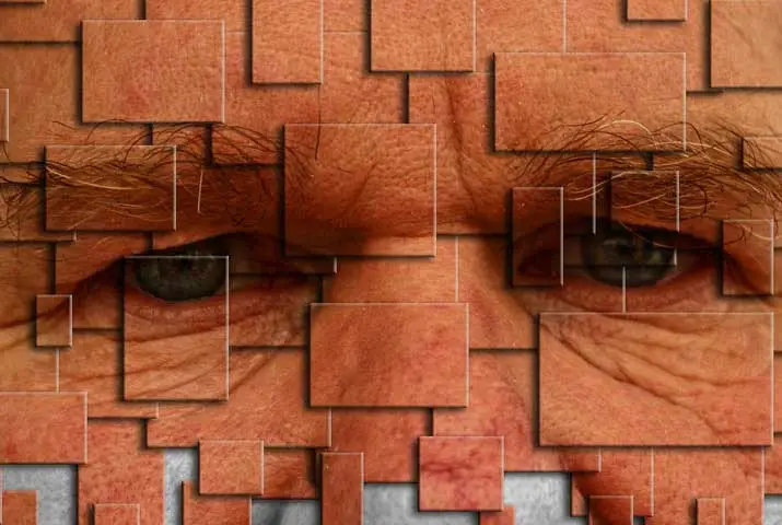 Close-up of a man's face with red square patterns resembling a photo collage