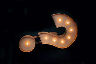 A question mark made out of lights with three bulbs lit up