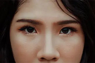 Close up of a woman's face showing her eyes, nose and mouth.