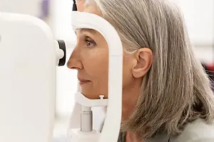 Old woman having her eyes checked by a doctor