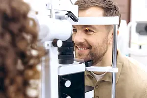 A man is getting his eyes examined in a clinic