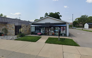 Image of a commercial building on a street corner with a closed sign