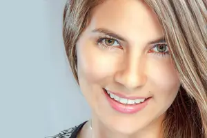 Close up of smiling woman with blonde hair and light makeup