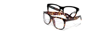 Two pairs of eyeglasses, one with black frames and clear lenses, the other with tortoiseshell frames and brown lenses, both displayed on a white background
