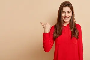 Woman pointing to her cheek and smiling