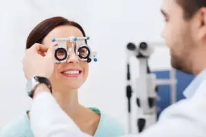 An optometrist is examining a patient's eyes in an optical shop.