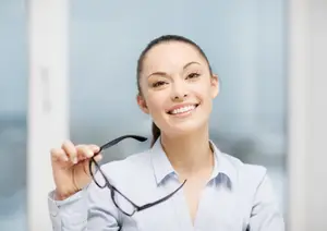 woman holding glasses and smiling