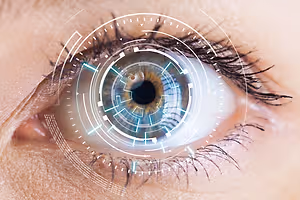 Close up of a woman's eye with a blue light and grid pattern superimposed on the iris.