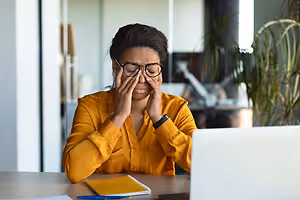 woman with headache in office