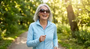 an older woman running in a park in a blue shirt