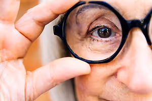 Senior woman adjusting her glasses to improve her vision
