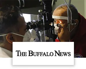 senior man undergoing an eye exam and The Buffalo News logo at the bottom