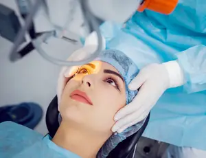 Woman receiving laser eye surgery in an operating room