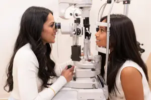 Female patient undergoing eye examination with optometrist 