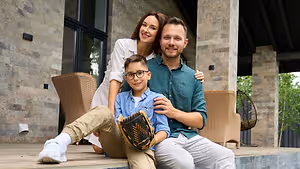 A family on the porch of their house.
