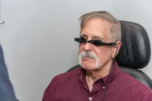 Man wearing glasses that are connected to a device