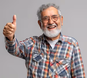 smiling elderly gray haired man in glasses shows thumbs up