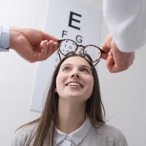 woman in glasses being examined by doctor