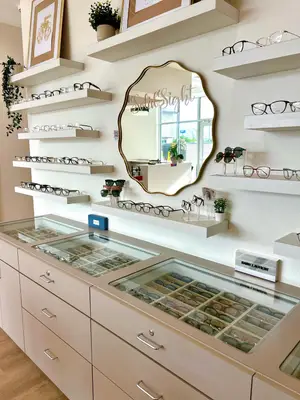 Glasses and sunglasses displayed on shelves and inside drawers in SolidSIGHT Eyecare