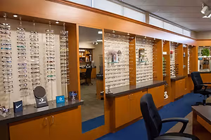 A store with many glasses on display and a blue floor.