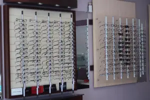 An image of a shop with different eyeglasses displayed on the wall, probably for sale